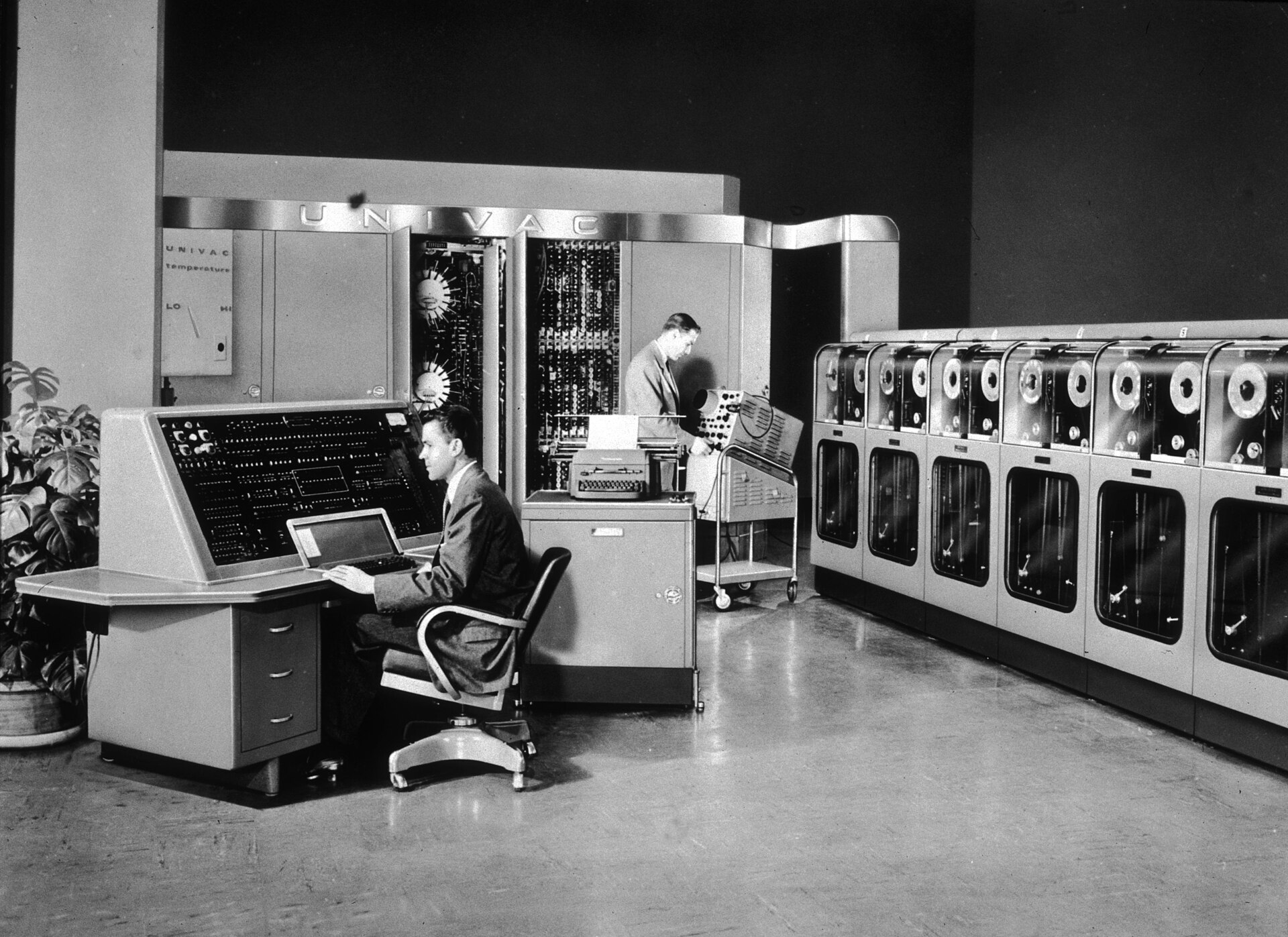 Two operators at the UNIVAC I console and tape drives, 1951